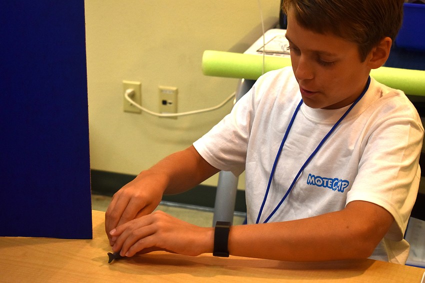 Luke Scheinoh moves a shark Lego piece for a Stopmotion video.