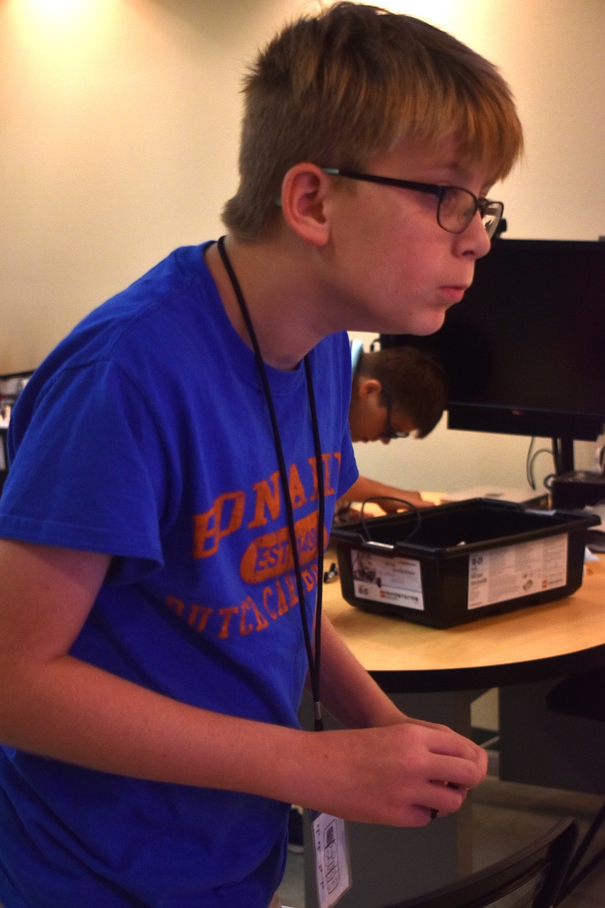 Henry Macke puts pieces together for the Lego Mindstorm.