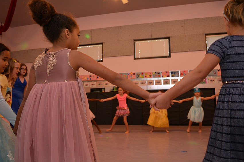 Andrea Vasquez and Juliette Gallen join for a group circle during a song from 