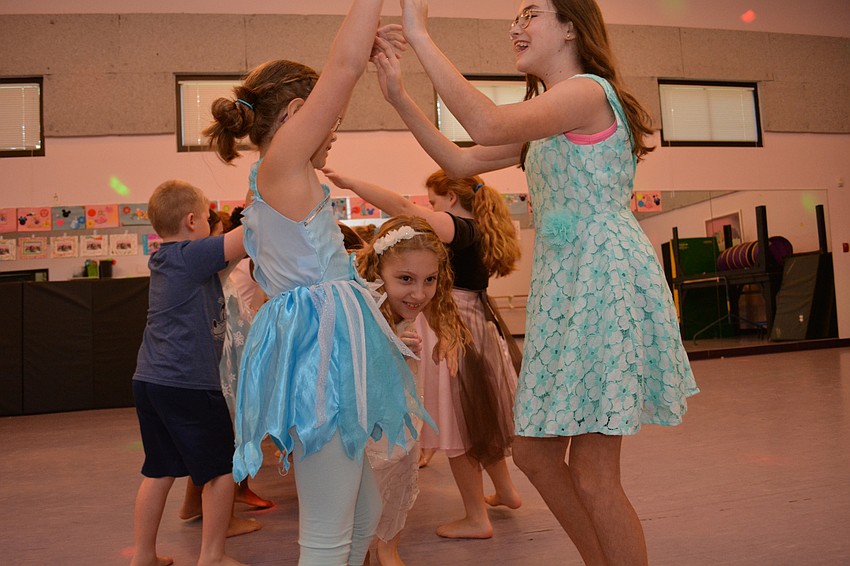 Rachel Gocinski barely makes it through a camper-formed bridge and emerges with a grin.