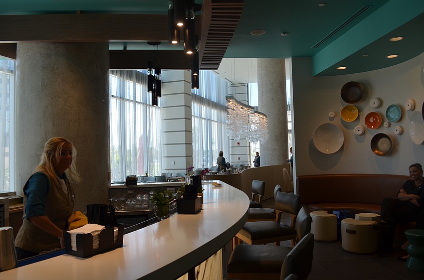 The second-floor restaurant, EVOQ, features the same aquatic imagery used throughout the hotel.
