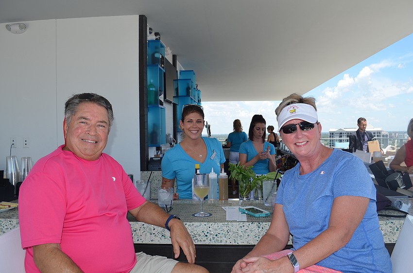Ron and Dee Cashman, left and right, were the first two customers at The Roof. Bartender Julie Asher, center, said both patrons and staff were excited for the business to open.