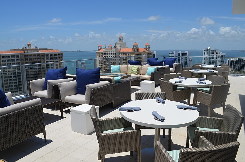 The waterfront development is located next to other high-rise buildings in the area.