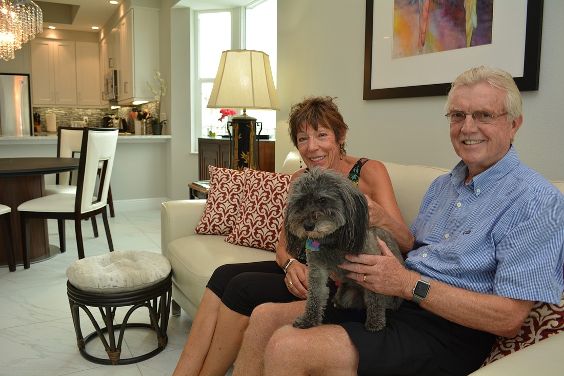 Sue and Colin Shaw, with their dog, Mia, love their new condo and its views of Lake Uihlein.