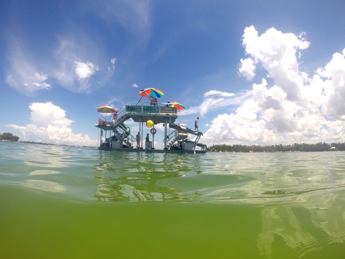 The floating water playground has made quite a splash around Longboat Key this summer. Some residents fear it disrupts the area. Photo by Anna Brugmann