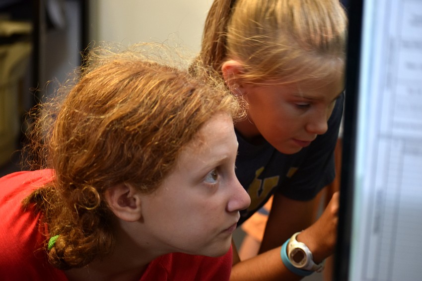 Ruby Jurgiel watches one of Mote’s turtles swim around his tank.