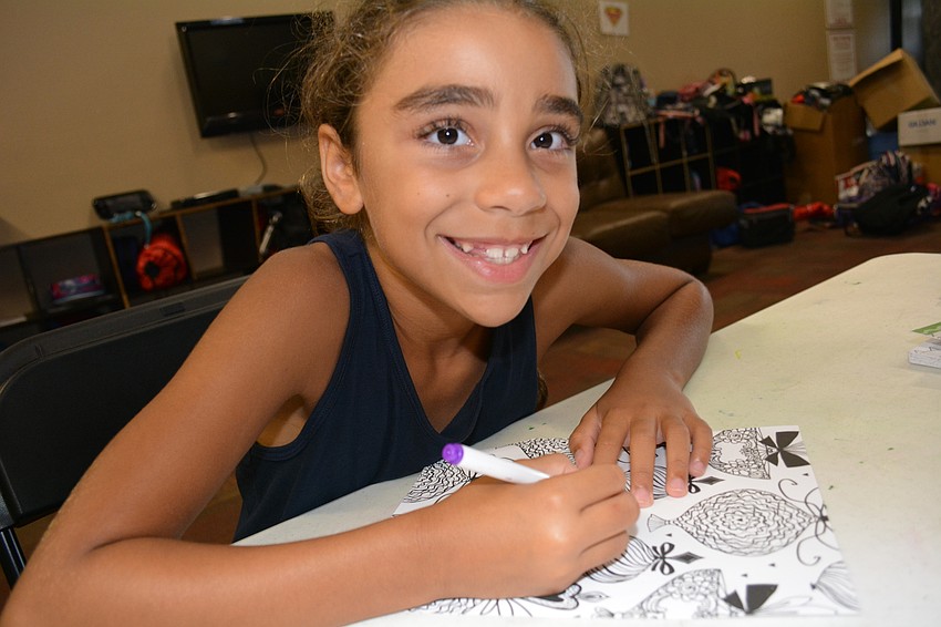 Willis Elementary's Allena Perez, 7, colors after returning from a field trip.
