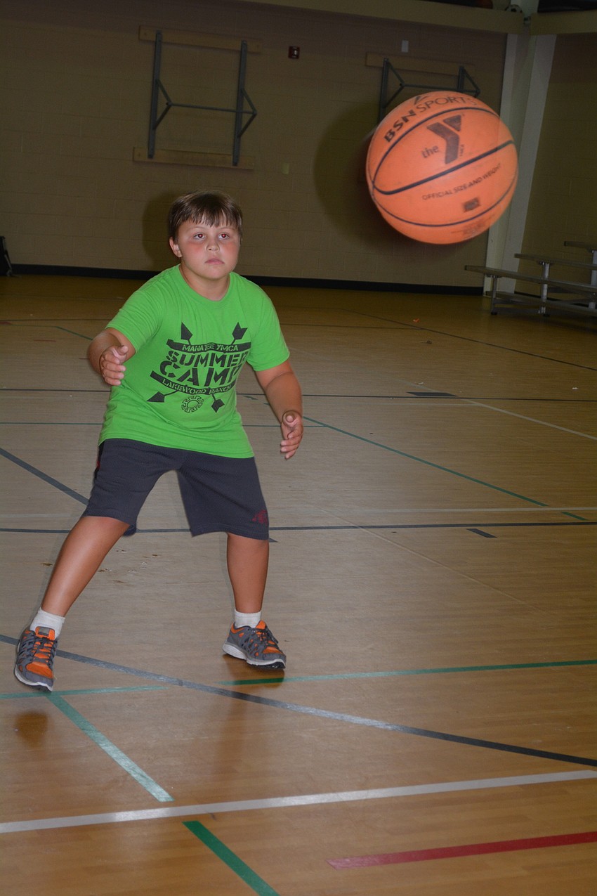 Trevor Morrell, of Rowlett Elementary, takes aim during a basketball game.