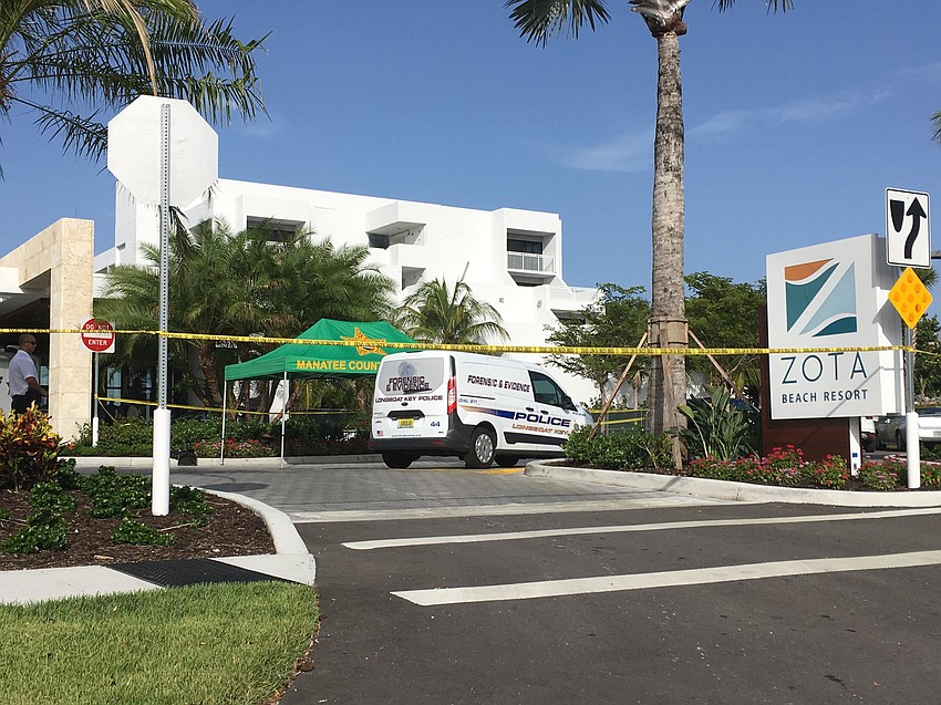 Police tape and squad cars surround the building at 4711 Gulf of Mexico Drive, in the Manatee County portion of the island.