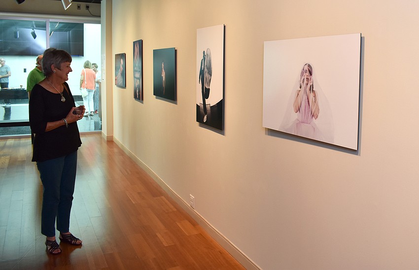 Guests admire the work on display at the PH_ashion 12 closing reception on August 4 at Richard and Barbara Basch Gallery.