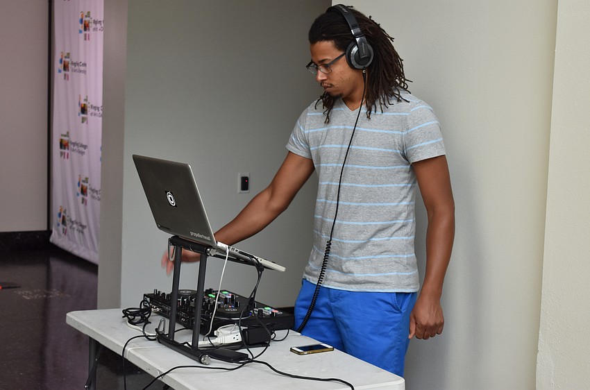 A DJ plays some jams for guests at the PH_ashion 12 closing reception on August 4 at Richard and Barbara Basch Gallery.