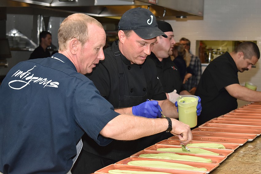 Event founder Steve Phelps and chef Erik Walker prep plates for the first course at the Fourth Annual Sustainable Seafood Dinner on Aug. 6 at Louies Modern.