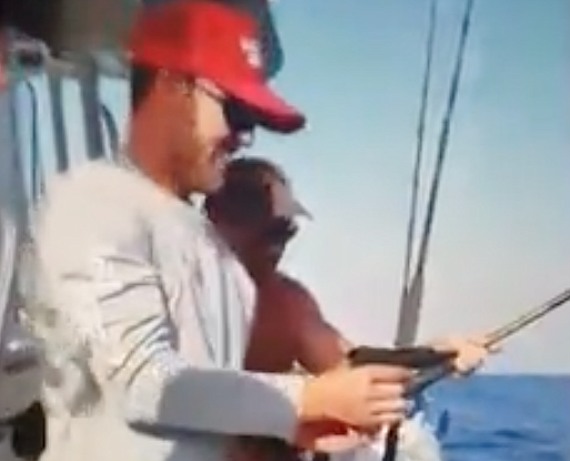A video posted to Alex Kompothecras&#39; Instagram page, which has since been deleted, depicts a man holding a shark on a line and shooting it several times in its side.