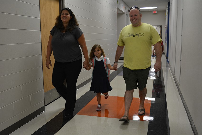 Kim and Eric Hale usher their new kindergartener, Tessa, to the Boo Hoo breakfast before class.