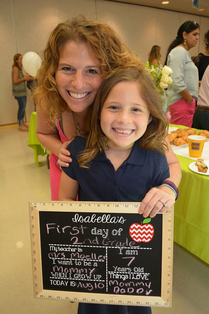 Lauren Navas makes sure her daughter, Isabella Navas, 7, gets a first-day photo.