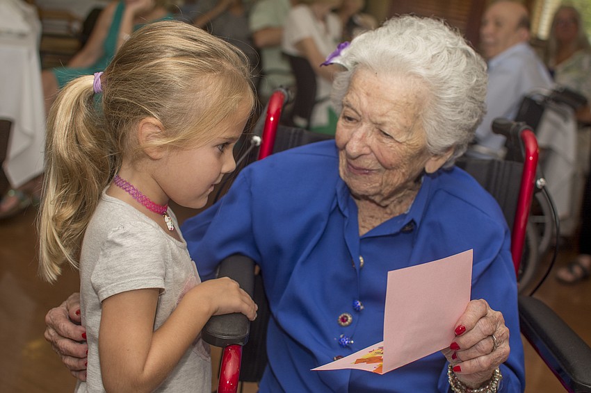 Eleanor Lando reacts to receiving a card from a student of the Pine's onsite preschool.