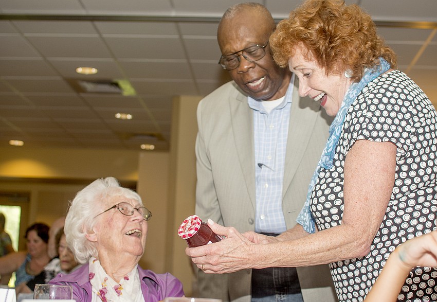 Marie Brandstatter, City Commissioner Willie Shaw and Pines of Sarasota Foundation President Estelle Crawford admire the custom jam jars each centenarian received.