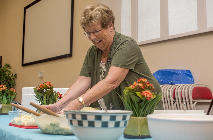 Judy Strauss sets side dishes on the buffet table at Christ Church's Fish Fry.