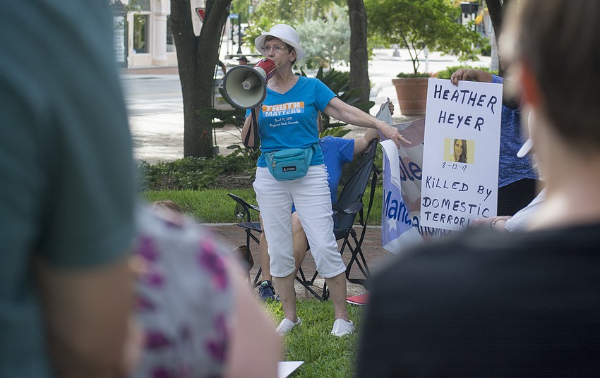Vigil Against Hate organizer Diane Perry welcomes demonstrators to the event.