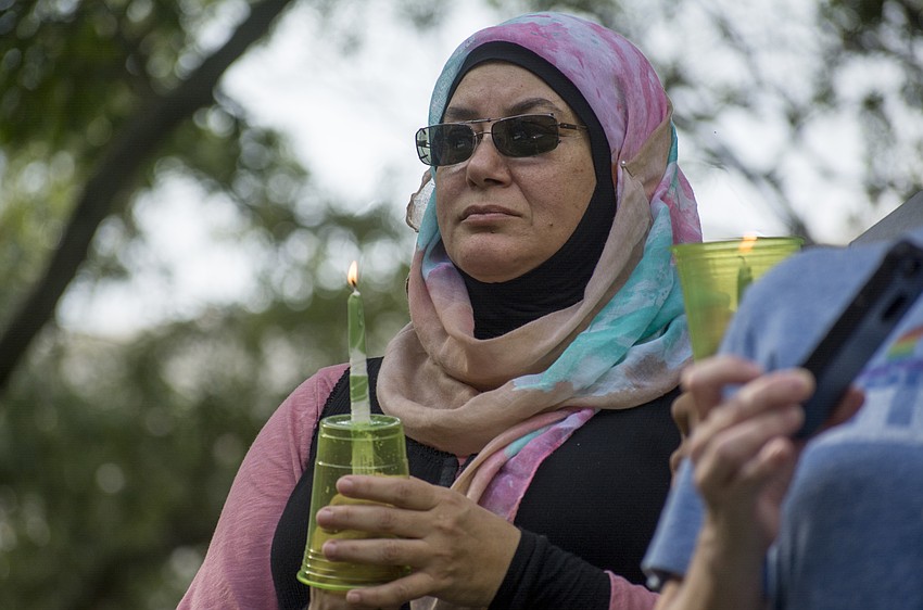 Amani Makarita holds a candle in Five Points Park during an Aug. 13 vigil for those killed and injured in Charlottesville, Va.