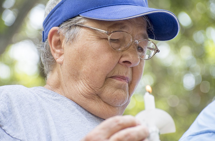 Bonnie Barton observes a moment of silence during the Vigil Against Hate in Five Points Park on Aug. 13.