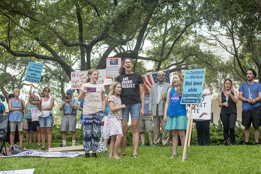Kenzie Mickish, Bridget Mickish, Karen Griffin and Tamina Mickish lead the crowd in singing “This Little Light of Mine” during the Vigil Against Hate in Five Points Park on Aug. 13.