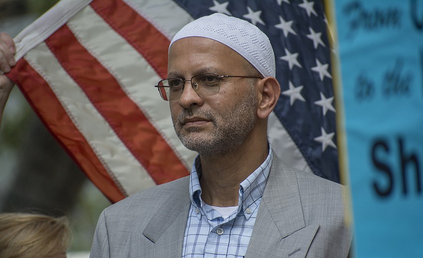 Hassan Hares listens to event speakers during the Vigil Against Hate in Five Points Park on Aug. 13.