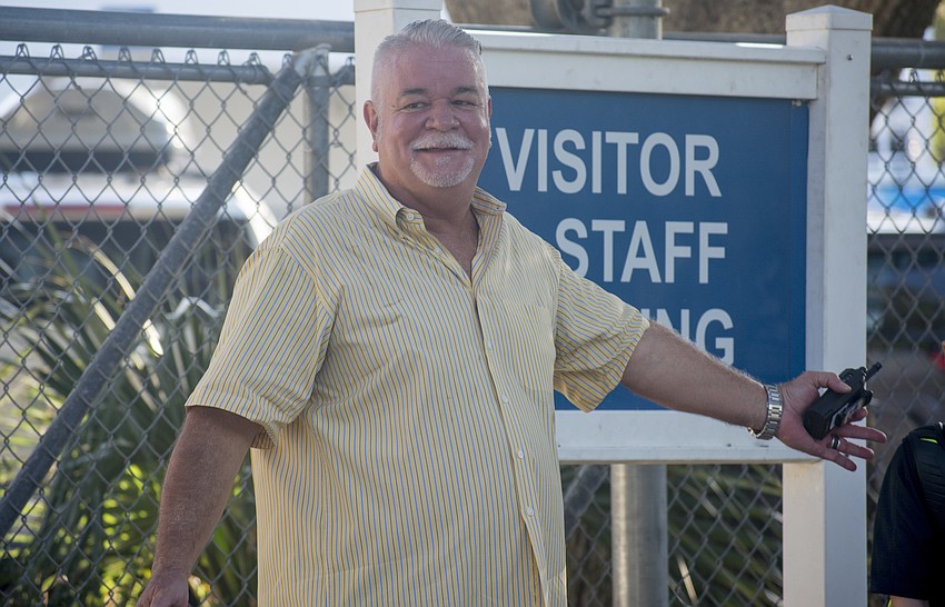 Southside Principal Steven Dragon helps parents and children across the street.