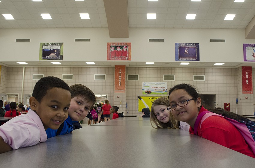 Fourth graders Caleb St. Louis Smith, Zachary Freeman, Sadie Ward and Lorena Garcia wait for school to start in the Alta Vista Elementary cafeteria.