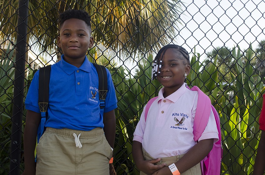 First graders Malik Hardy and Serenity Jackson just stepped off the bus on their first day at Alta Vista Elementary.