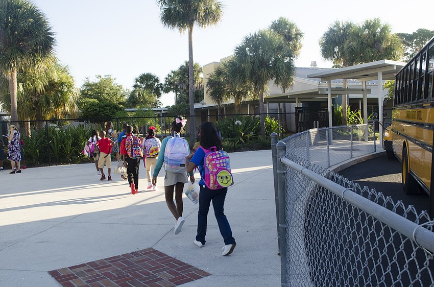 Students get off the bus at Alta Vista Elementary and head to the first day of classes.