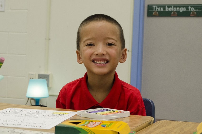 First grader Channing Riley colors as he waits for all his classmates to arrive at Alta Vista Elementary.