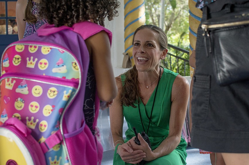 School Counselor Tammy Blake welcomes students to Bay Haven Elementary.
