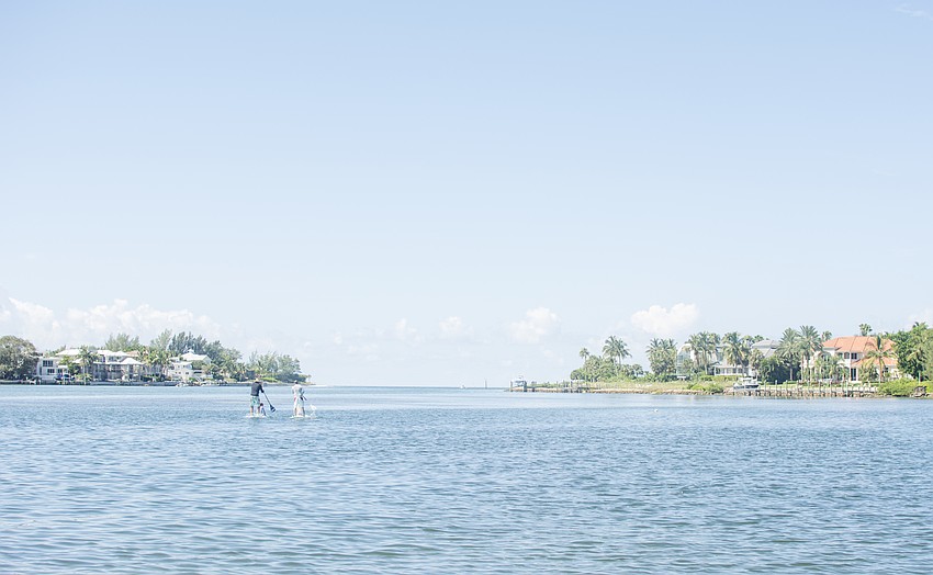 Volunteers take out stand up paddle boards on New Pass.