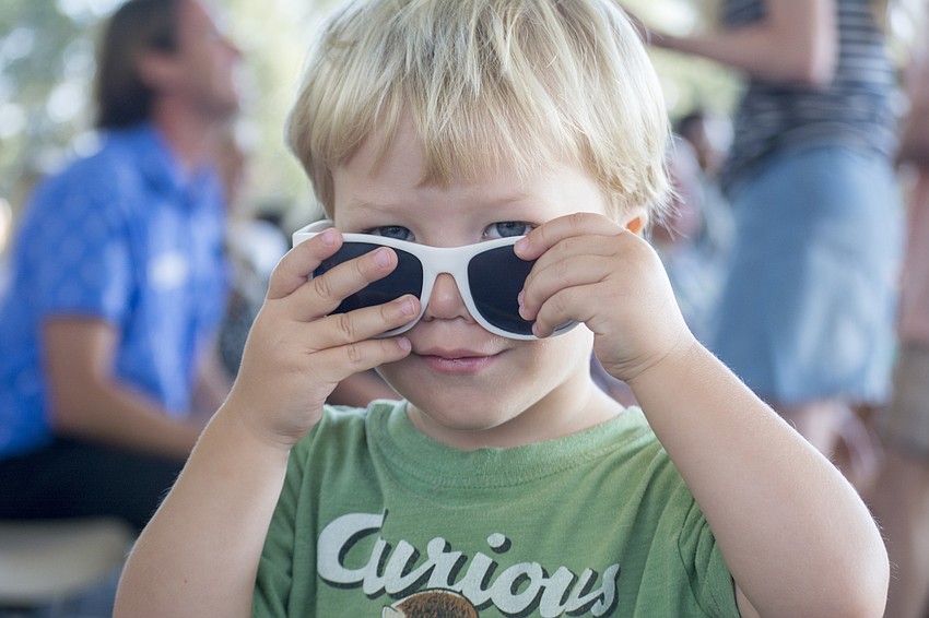 Patrick Rauch tries on his ODA sunglasses, which were passed out before the assembly in honor of the school's recent solar energy project.