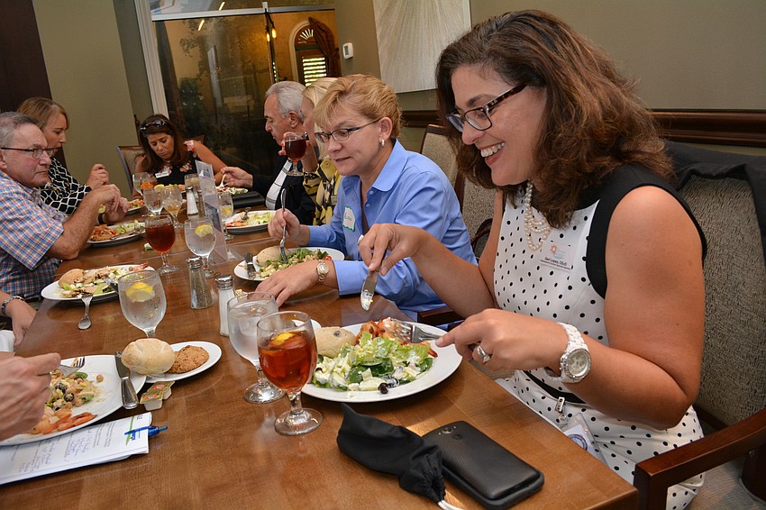 Manatee County's Director of Redevelopment and Economic Opportunity  Geri Gomez grabs a quick bite with tour-goers before sharing about the county's affordable housing and incentive programs.