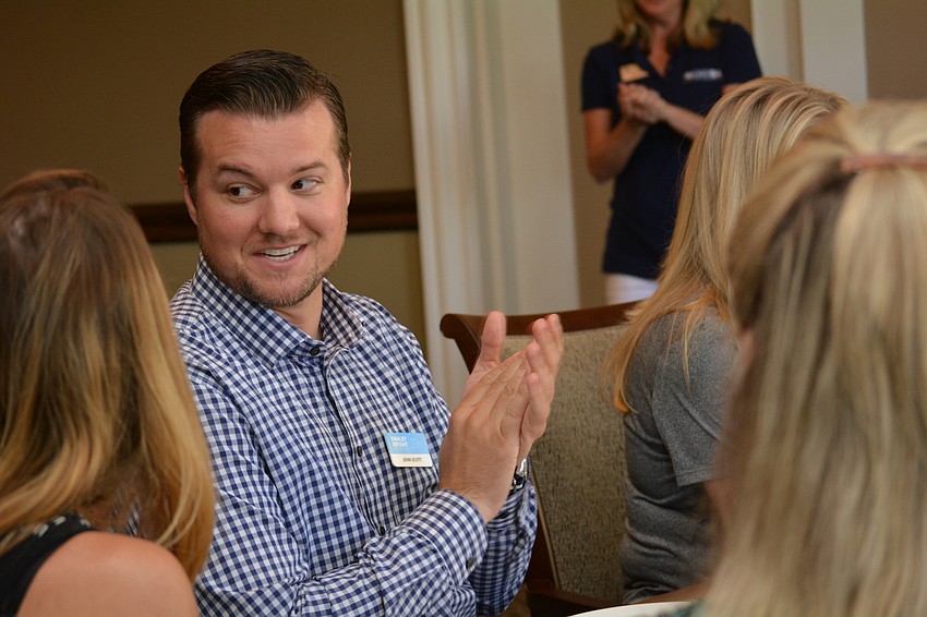 Fawley Bryant's John Scott claps for a speaker during lunch at the Lakewood Ranch Golf and Country Club.