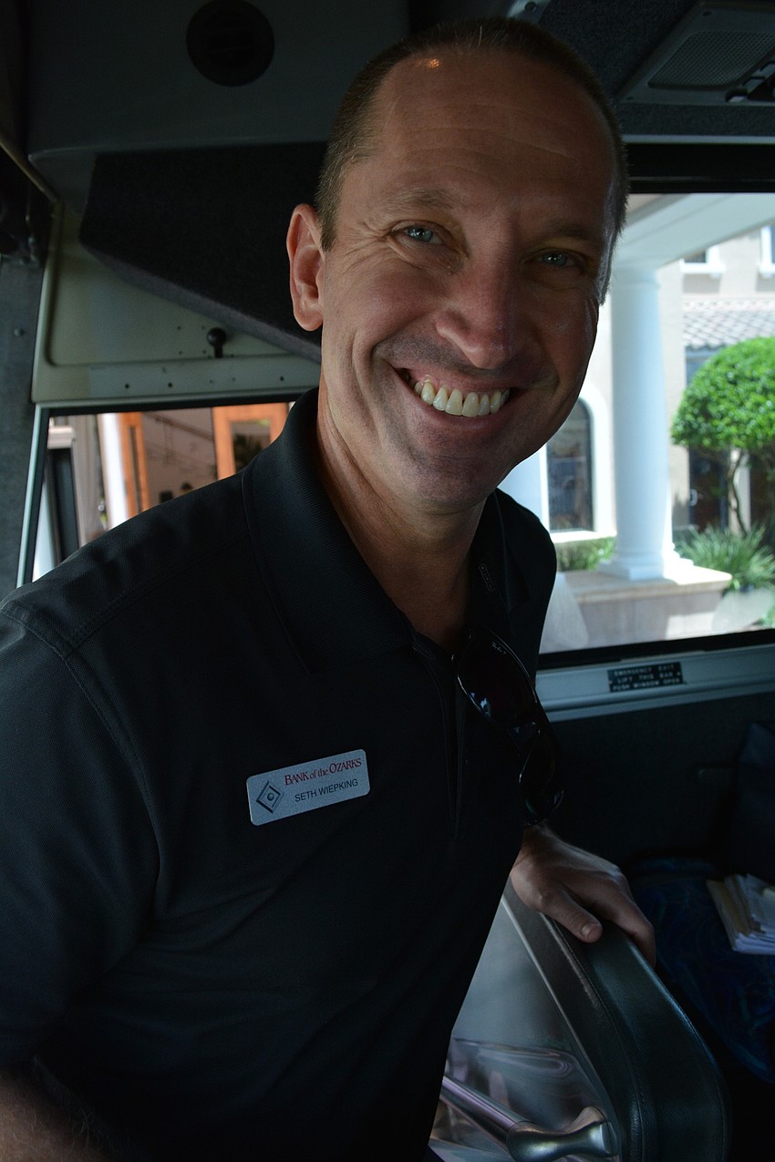 Seth Wiepking, of Bank of the Ozarks, is al smiles climbing back onto the bus for the second half of the day.