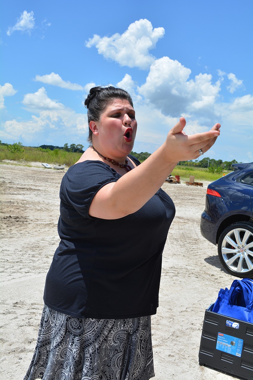 The Players Centre for Performing Arts performer Alyssa Goudy serenades tour-goers from a tent near The Player's future building site. She sings 
