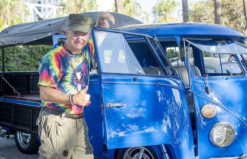 Chris Joyce poses next to a vintage Volkswagen van.