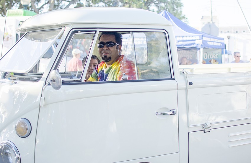 Octavio and Gustavo Galarza pull into the downtown Farmers Market in a vintage Volkswagen utility vehicle.