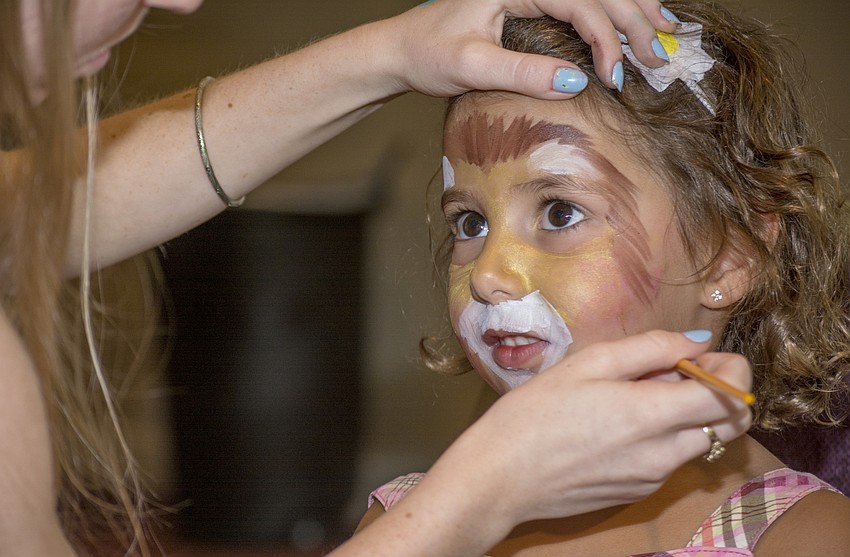 Eden Tibi sits while getting her face painted during Temple Sinai's Religious School Kick Off Party.