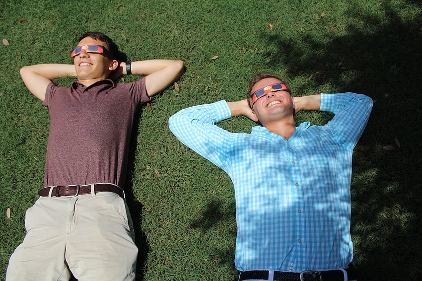 Out-of-Door Academy seniors Christopher Eckart and Michael Gosnell take their first look at the solar eclipse.