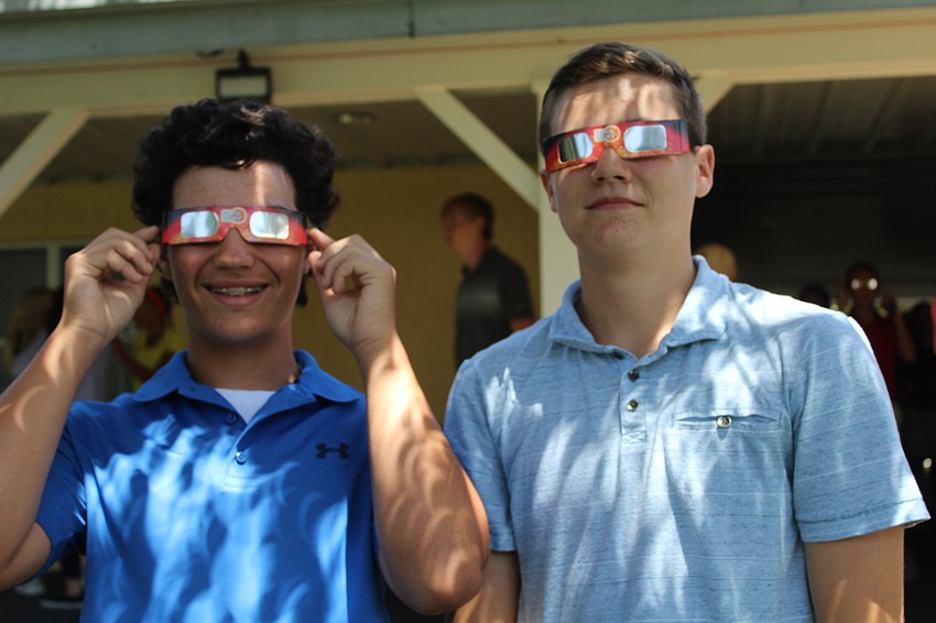 Out-of-Door Academy ninth-graders Tyler Colditz and Ryan Kelly practice with their solar eclipse glasses.