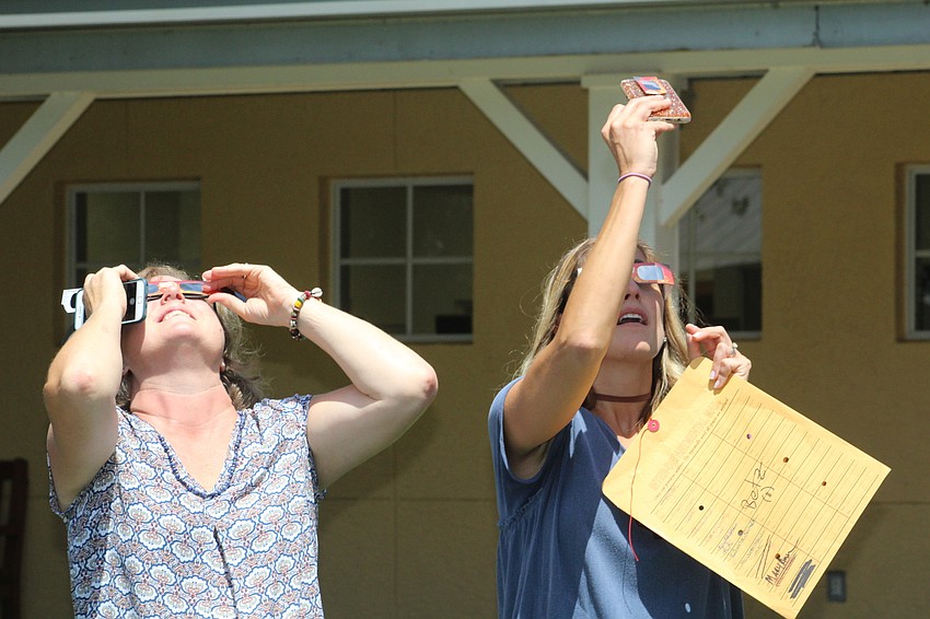 Out-of-Door Academy 10th-grade teachers Camela Giraud and 11th-grade teacher Stefanie Betz sport their solar eclipse glasses.