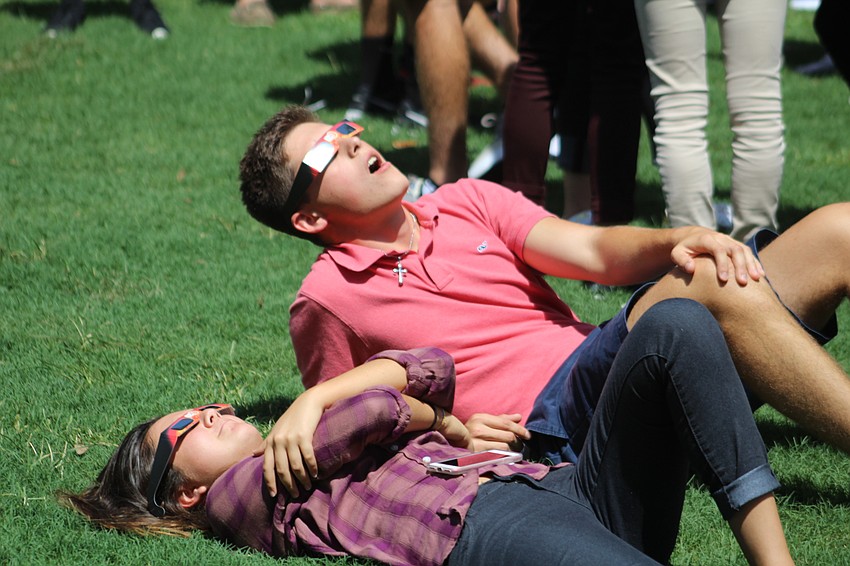 Out-of-Door Academy junior Kat Gaukhman and senior Phillip Cecil have the perfect angle to enjoy the eclipse.