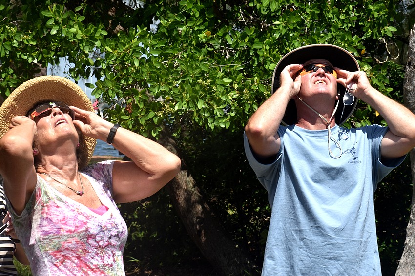 Christina Burns and Tom Roberts watch the solar eclipse.