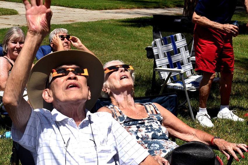 Ray and Lynne Woo watch as the moon passes over the sun.