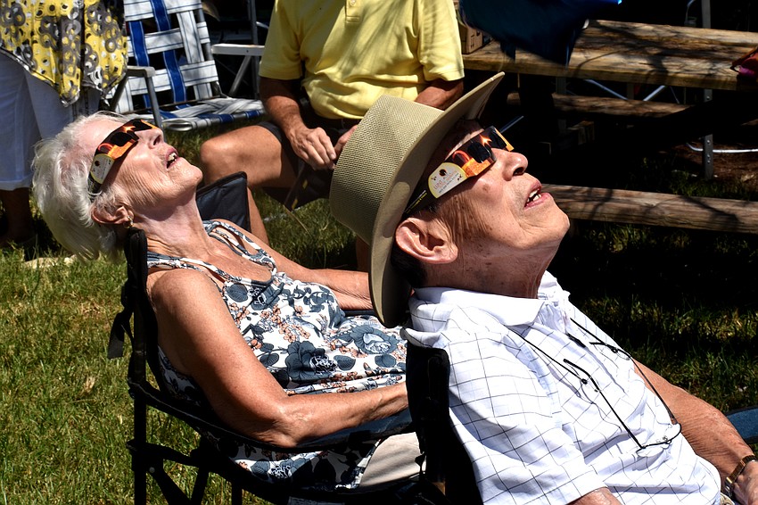 Ray and Lynne Woo watch as the moon passes over the sun.