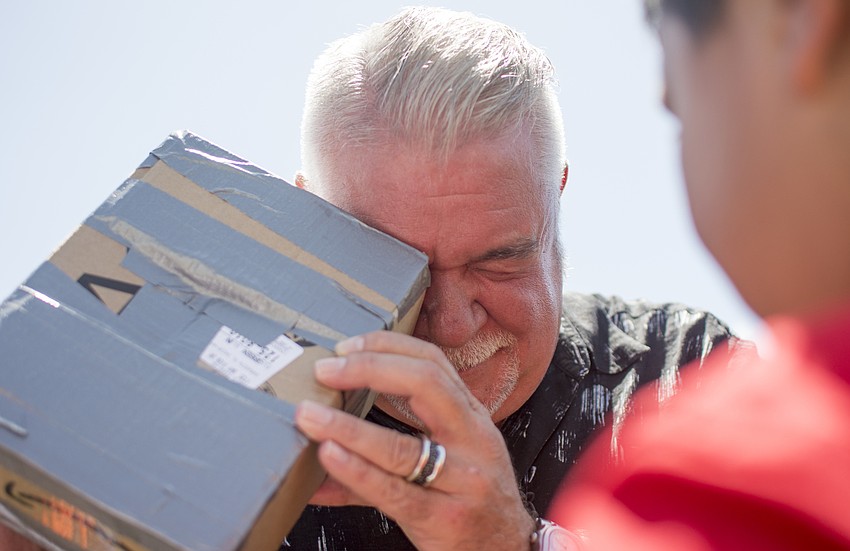 Southside Elementary School Principal Steven Dragon uses a shoe box viewing device to watch the solar eclipse.